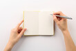 © New Africa - Woman writing in notebook on white background, top view
