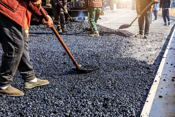 Wall Mural - Teamwork, Workers laying asphalt road at construction site.