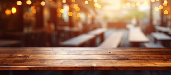 Poster - A wooden table made of hardwood plank with a wood stain finish. It is varnished and perfect for events. The blurry background hints at a restaurant setting