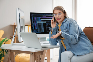 Female programmer working at table in office