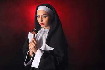 Wall Mural - Naughty nun with cross on dark background