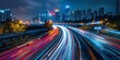 © ParinApril - Long exposure of city highway traffic at night with neon light trails.