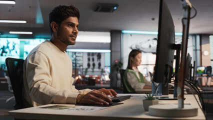 Aufkleber - Indian Male Game Designer Using Desktop Computer With 3D Modelling Software To Design Unique Characters And World For Immersive RPG Video Game. Man Working In Game Development Company Diverse Office