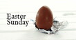 Image of easter sunday over chocolate egg on white background