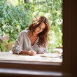 © Mariusz/peopleimages.com - University student, woman and write notes to study for revision, exam preparation at home. Female person outdoor and diary with test or assignment deadline and schedule for distance learning