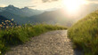 Alpine Bliss: Sunlit Gravel Trail Amid Majestic Peaks. Generative AI