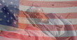 Image of flag of united states of america over senior biracial couple in deckchairs on beach