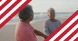Image of flag of united states of america over senior biracial couple dancing on beach