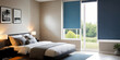 Blue blackout roller blind on windows in stylish modern badroom. Shutters on the plastic window.