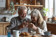 © Pattanan - senior woman and man couple point to mobile phone, speaking to his wife during breakfast in home, texting smartphone and enjoy time together