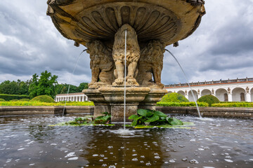 A beautiful historic sculptural fountain the Flower Garden in Kroměříž, a UNESCO World Heritage Site, with blooming ornamental flower beds and geometric hedges