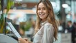 © Viewvie - Portrait of happy young businesswoman working at office. She is holding document for copy by printer laser.