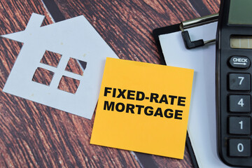 Concept of Fixed-Rate Mortgage write on sticky notes isolated on Wooden Table.