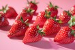 Scattered strawberries on pastel pink for vibrant food imagery