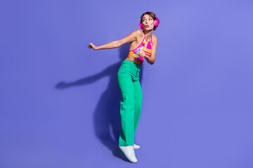 Poster - Full body size photo of young lady thin body wear crop top and pants dance with headphones look novelty isolated on purple color background