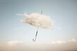 © Cristina Conti - surreal cloud cover of an umbrella flying in the sky, abstract concept