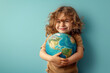 Cute kid close up holding planet