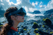 © yaqui_villegas - Woman wearing a VR headset stands against a dramatic landscape, the image conveys a sense of discovery and wonder