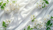 jasmine branches, white flowers on satin fabric with smooth folds, white background, empty space for text in the center, spring
