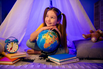 Poster - Photo of dreamy adorable little preteen girl dressed casual style investigating planet sitting hovel indoors house home room