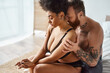 diverse couple, bearded man with tattoos and black woman sharing a tender moment in bedroom