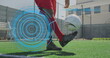 Image of scope scanning over football player with prosthetic limb kicking ball