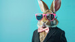 rabbit wearing suit, pink sunglasses and bow tie on blue background
