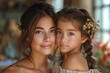An elegant snapshot of a loving mother and daughter with beautiful features and ornate hair accessories