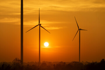 Wall Mural - electric wind turbine and the sun in the morning.wind energy, electricity production plant. high vol