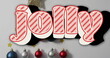 Image of jolly text over christmas baubles