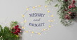 Image of merry and bright text over christmas decorations