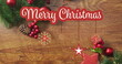 Image of merry christmas text over christmas decorations