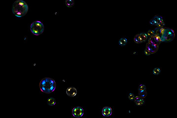 Wall Mural - Soap bubbles isolated on a black background.