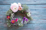 Fototapeta Tulipany - Spring floristry with herbs and flowers on weathered wood. Natural spring decoration. Top view.