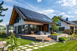 Modern house with solar panels on the roof and grass in the yard