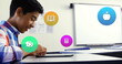 Image of colorful icons over biracial schoolboy using tablet