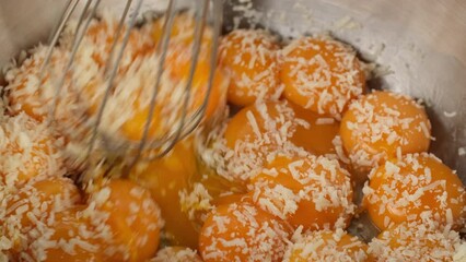 Wall Mural - Raw chicken egg yolks and grated cheese mixing in plate