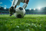 Fototapeta Sport - Close up Soccer player's feet kicking the ball on the green stadium of the football field