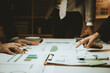 © Kritdanai - economic concepts Business and partner plan data analysis to determine the direction of the company's business investment in the workplace. Night Marketing Consultant Concept