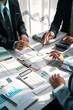 © Nittaya - Team of business people are meeting to analyze data for marketing plan,Market research reports and income statistics, Financial and Accounting concept.