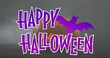 Image of happy halloween text with bat over orange carved pumpkin