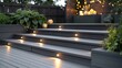 Ash grey composite decking: two-tiered design with deck lights - perfect for landscape gardening projects
