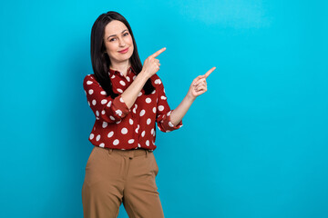 Wall Mural - Photo portrait of attractive woman point empty space banner shopping dressed stylish dotted red clothes isolated on blue color background