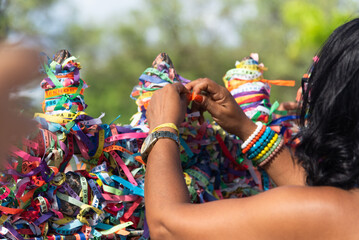 Wall Mural - A Catholic faithful is seen tying a souvenir ribbon on the railing of the Senhor do Bonfim church in the city of Salvador, Bahia.