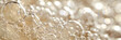 A closeup surface of sparkling wine with bubbles and foam. champagne bubbles, yellow foam texture background,banner