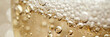 A closeup surface of sparkling wine with bubbles and foam. champagne bubbles, yellow foam texture background,banner