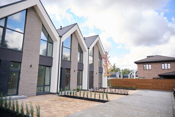 Two storey contemporary houses standing in line in suburban area