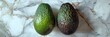 © artdolgov - Two perfect avocados on a background of white marble with gold veins, top view. daylight bright light. Space for text