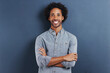 Portrait, smile and black man with arms crossed, fashion and afro on a blue studio background. Face, African person and model with casual outfit and stylish clothes with confidence and mockup space