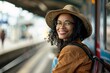 Black woman with a serene smile, sitting on a bench at the train station platform